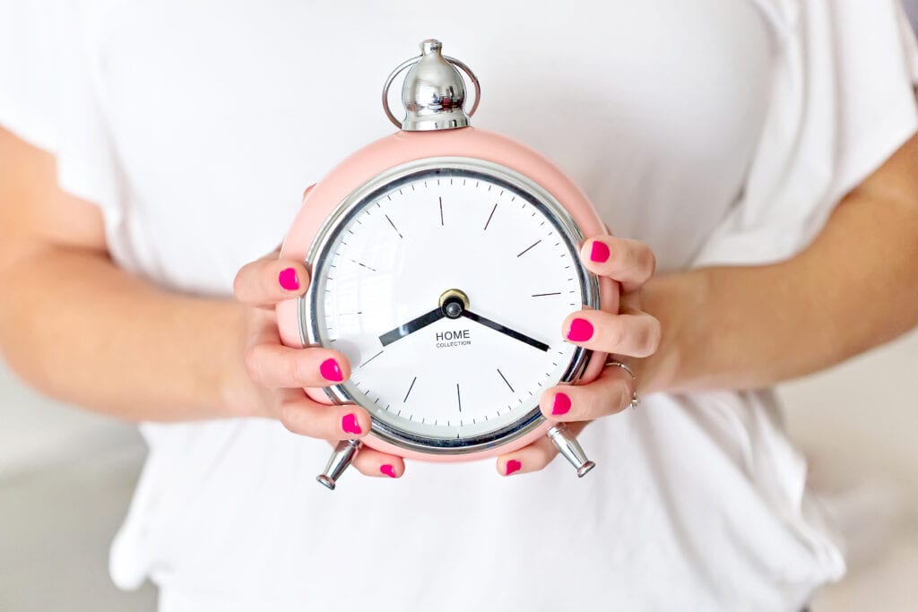 content creation | photo of a woman holding a clock