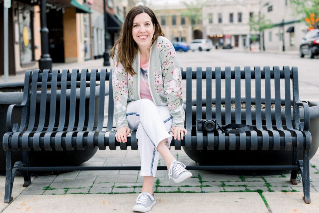 Allison Scholes, boss lady in sweatpants, on a park bench with her camera | she will help you clarify and build your Instagram presence