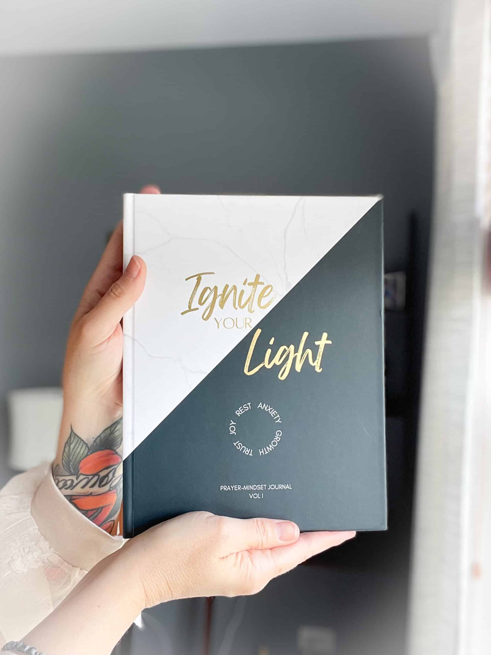 Allison Scholes holding the new prayer-mindset journal: Ignite Your Light