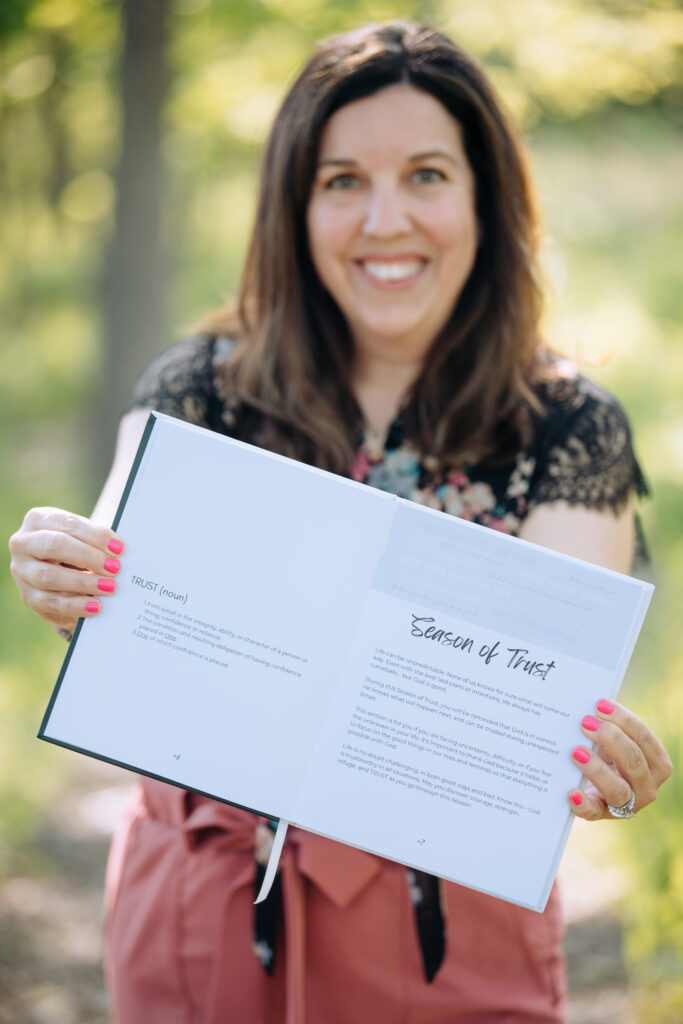 photo of Allison Scholes holding the Ignite Your Light journal